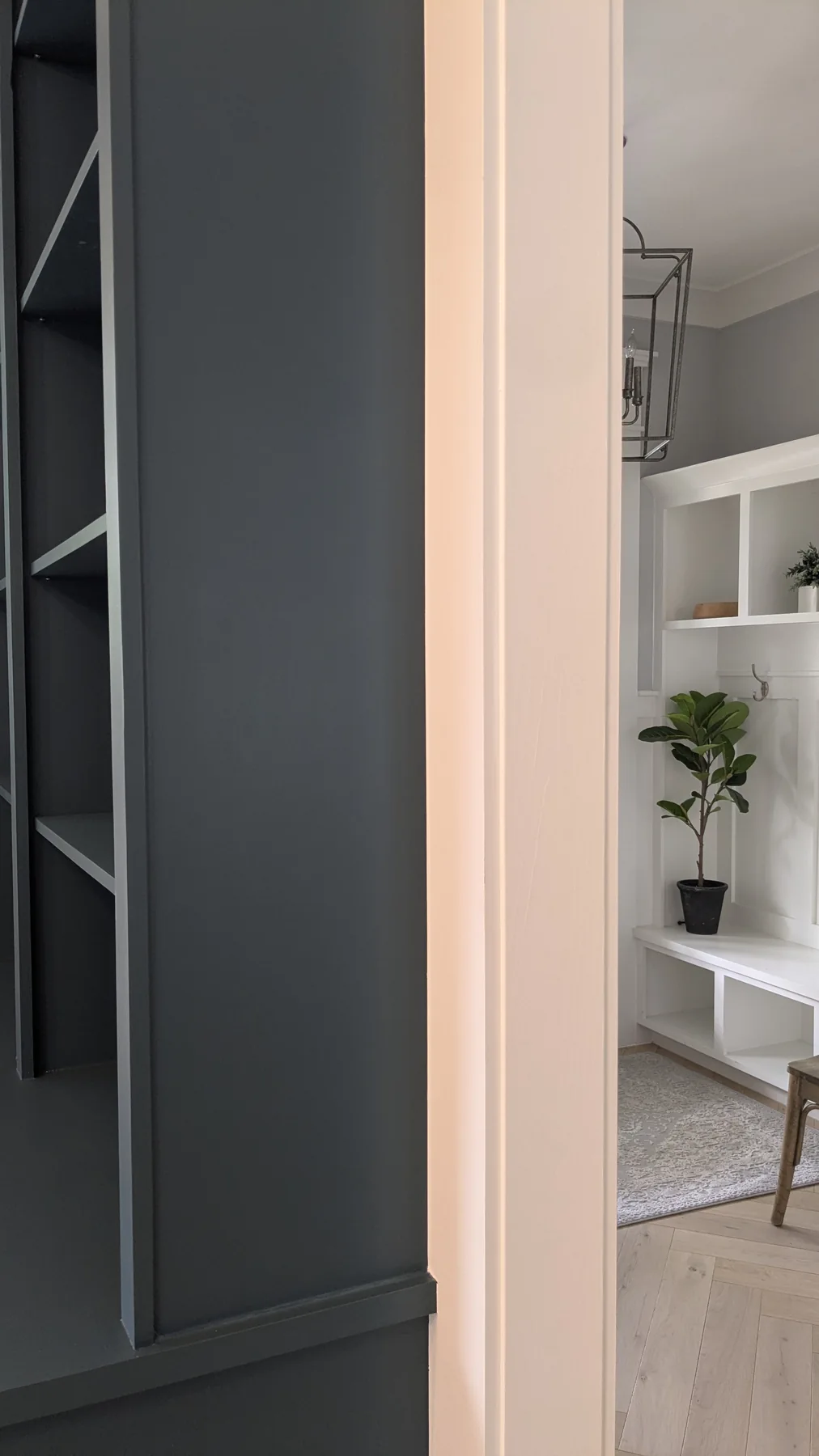 Painted decorative panel on the side of a blue built-in cabinet