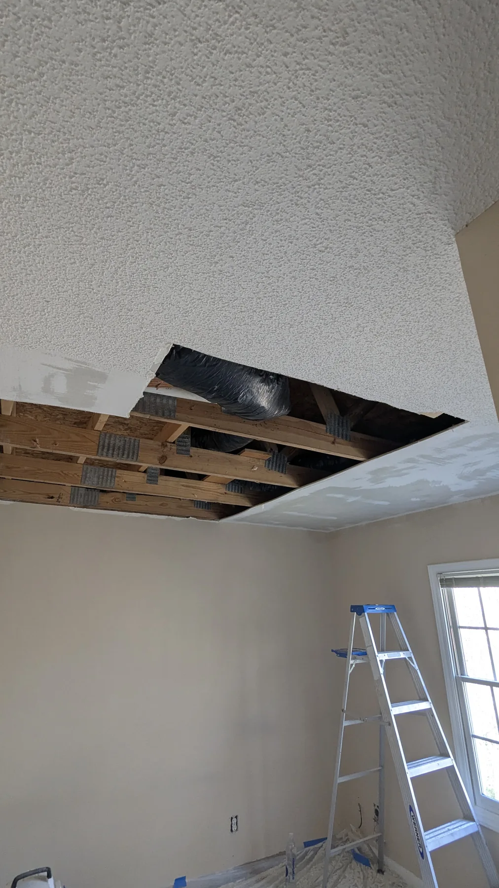 Ceiling opening and exposed framing during repair work