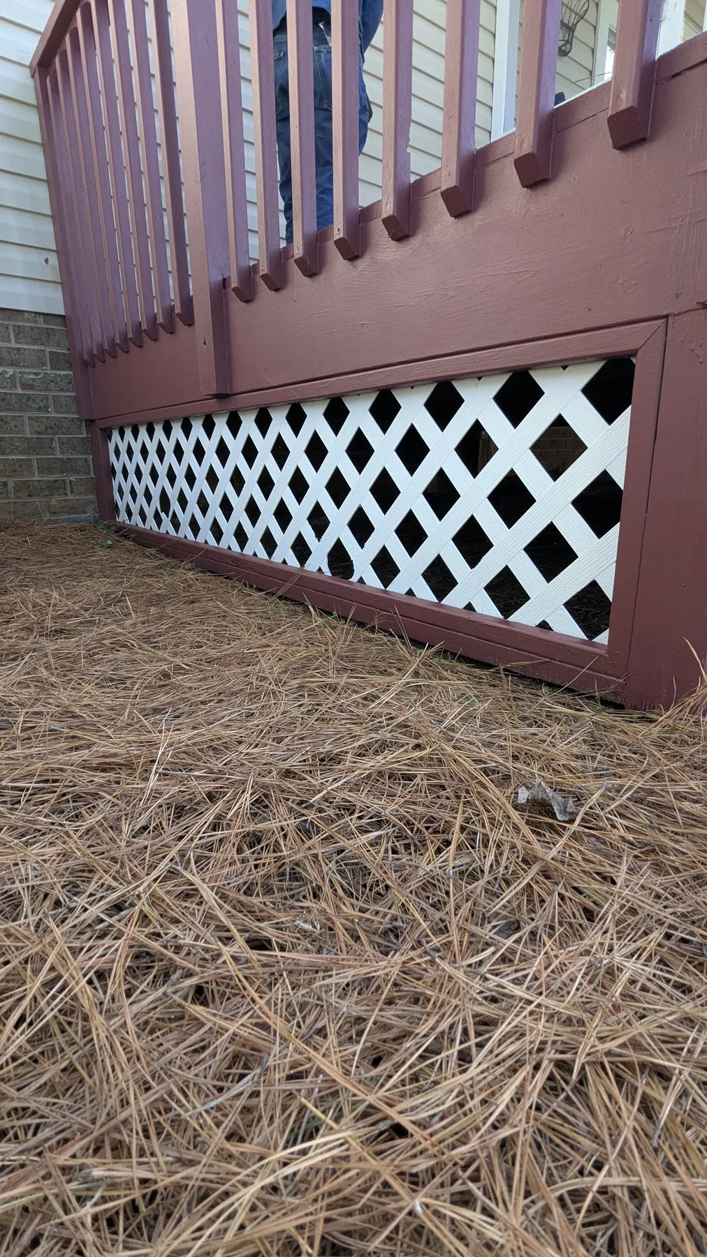 Red deck framing with white lattice below