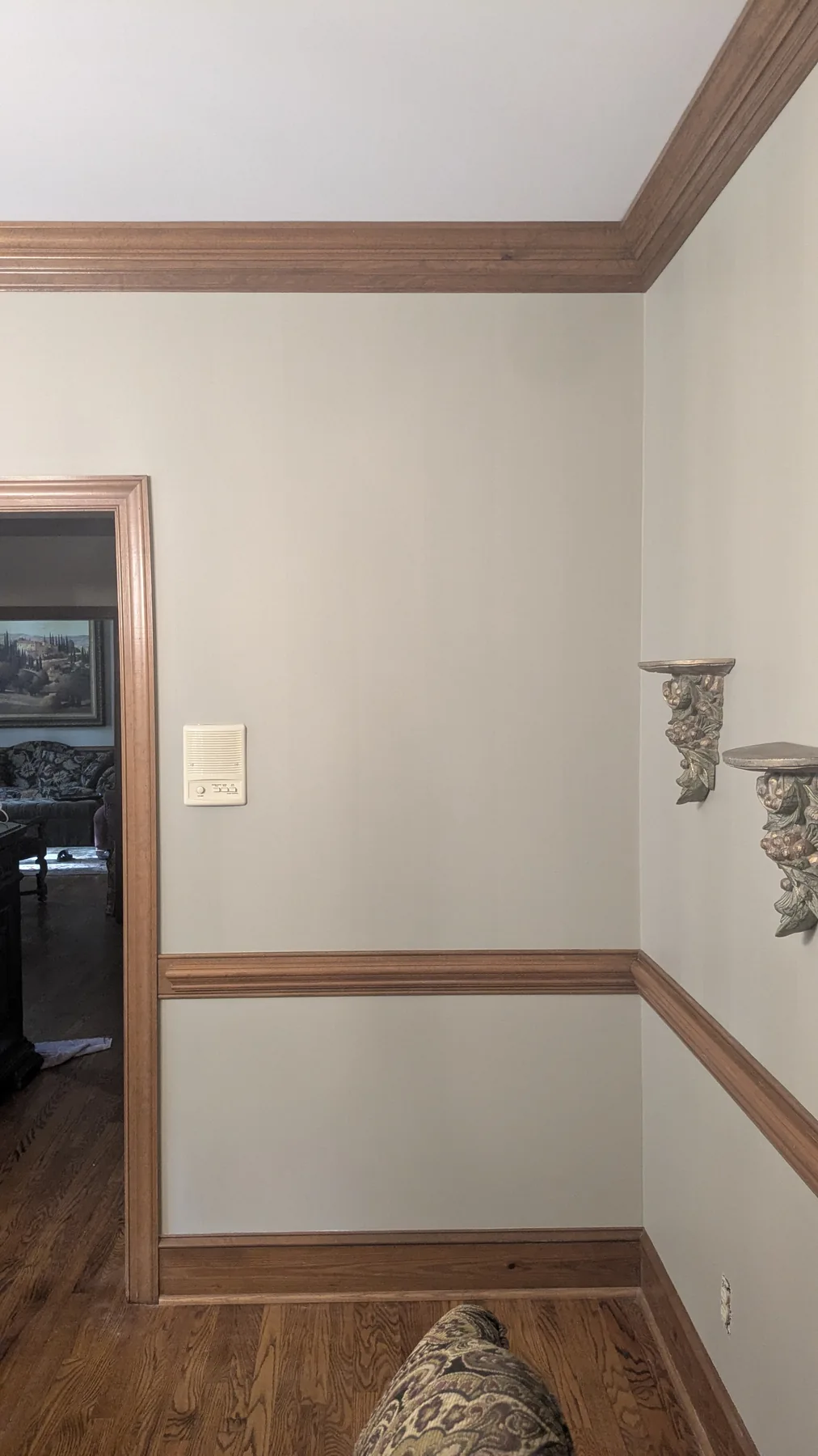 Light painted dining room walls with natural wood chair rail and trim