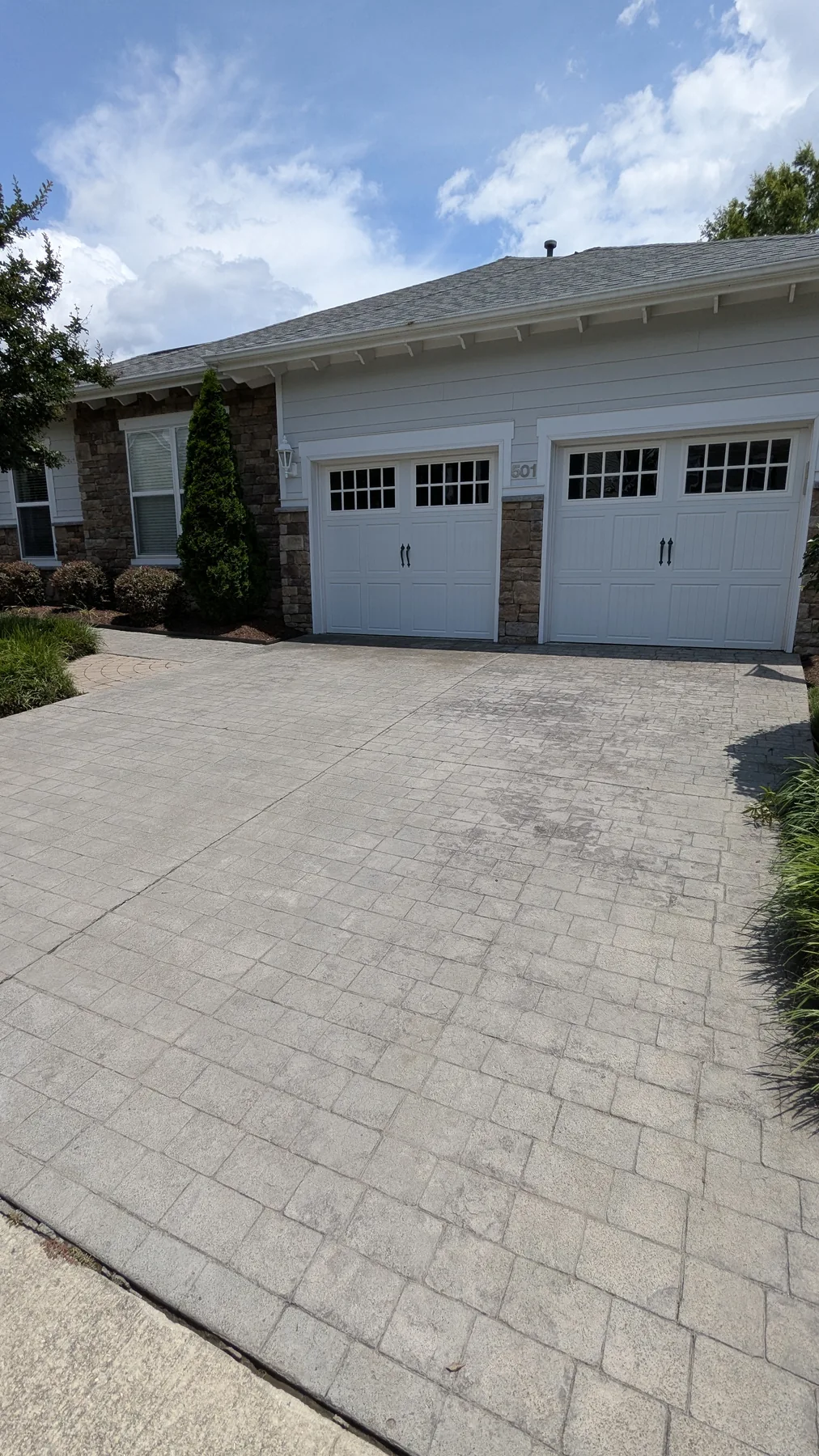 Clean paved driveway in front of a garage