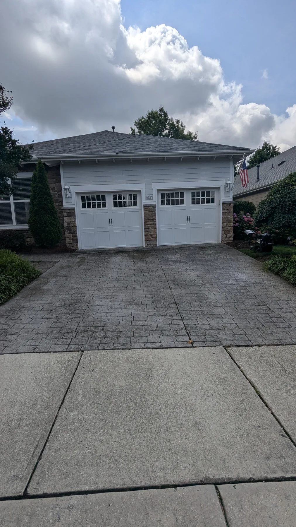 Driveway with visible surface staining before washing