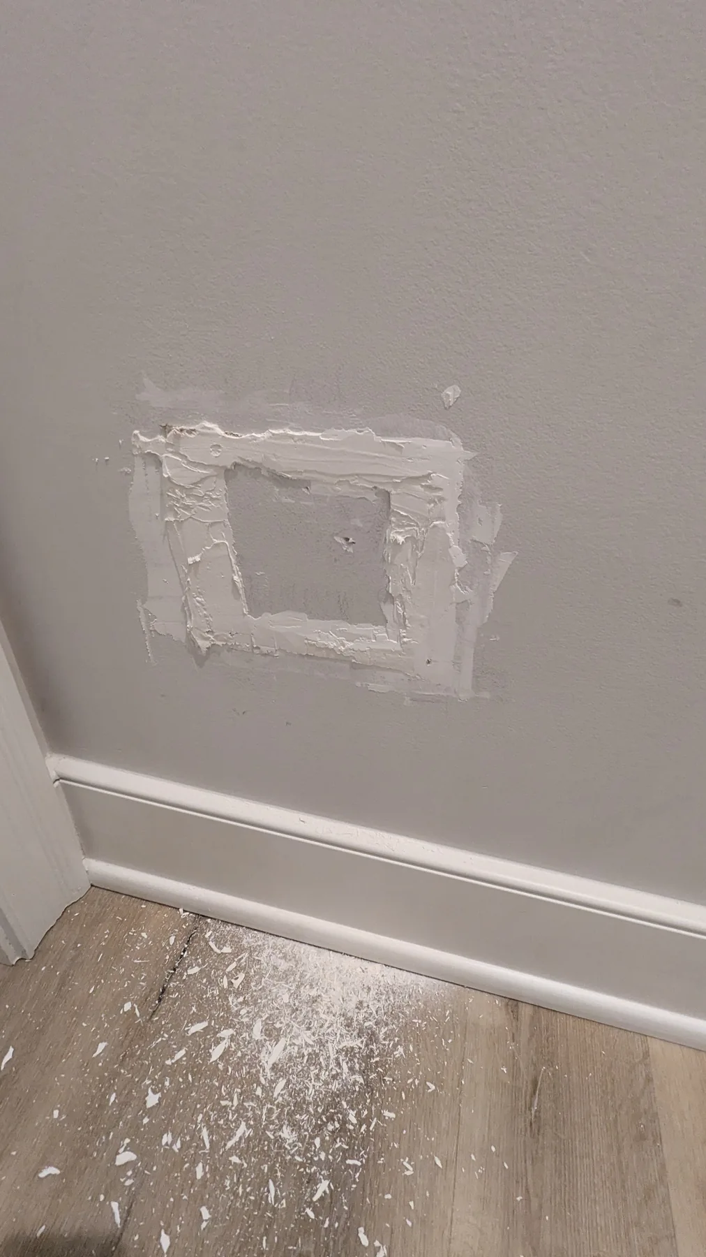 Small drywall patch being prepared for painting