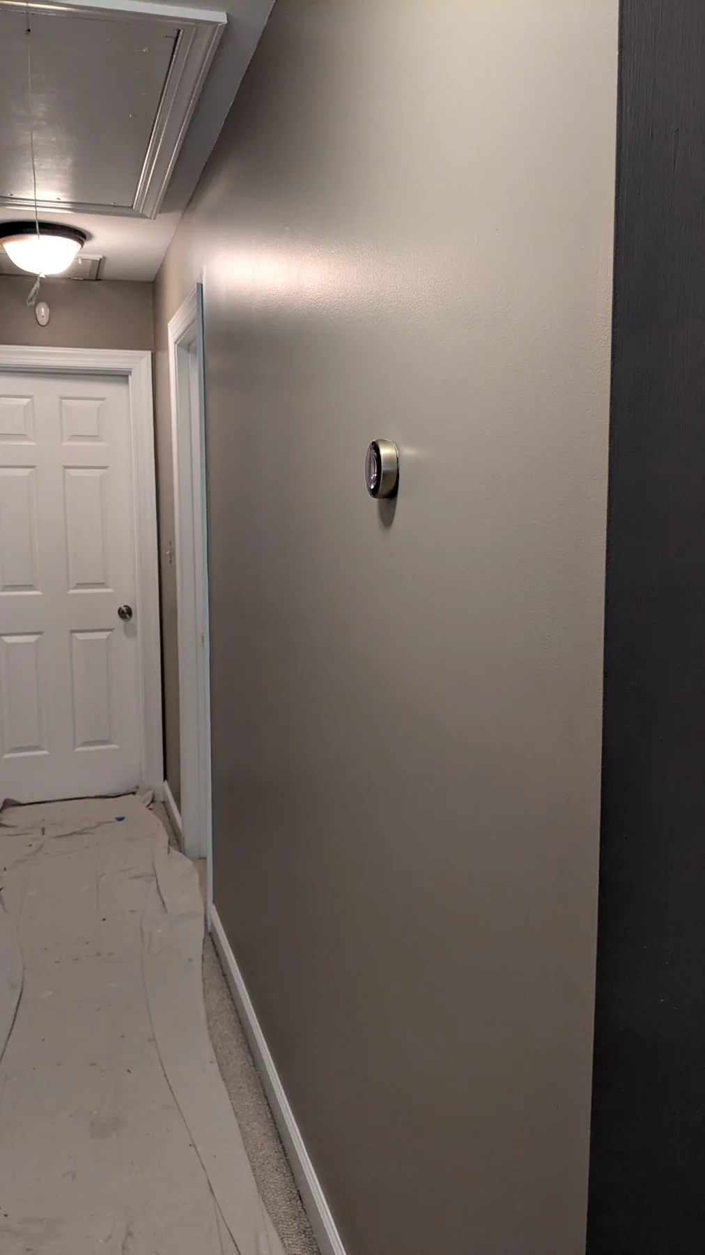 Hallway with gray painted walls and white door frames
