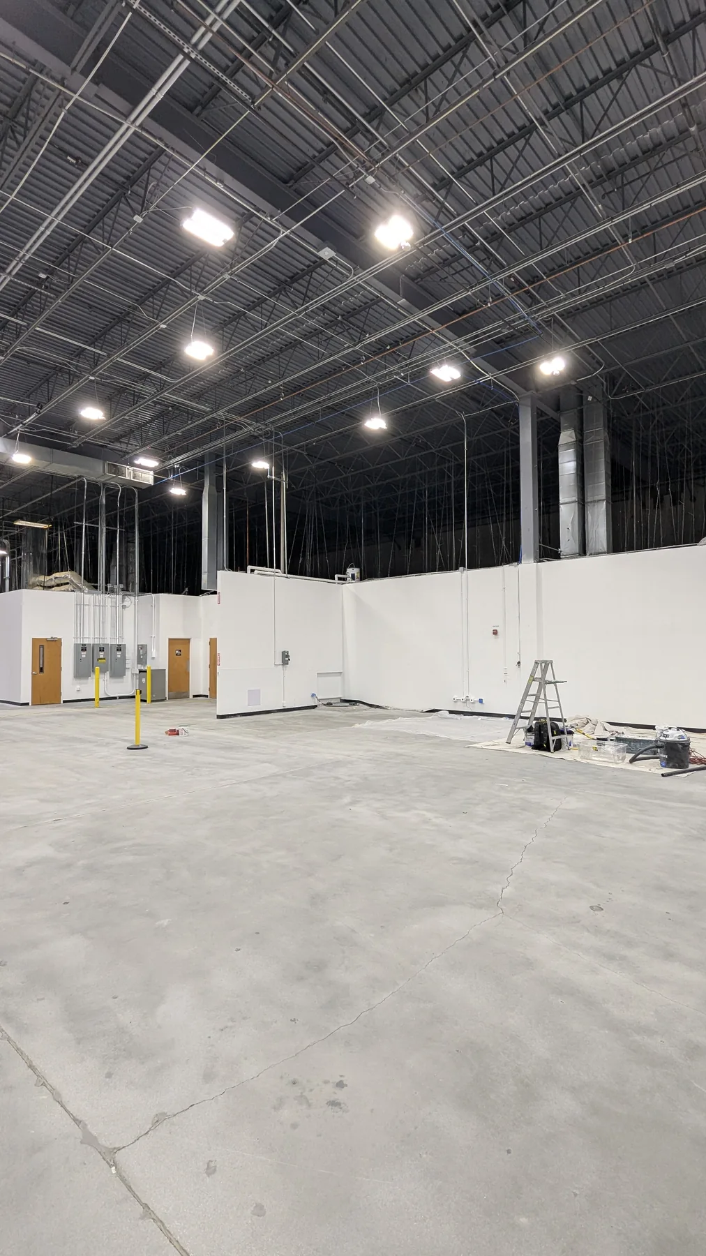 Wide commercial interior with white painted walls