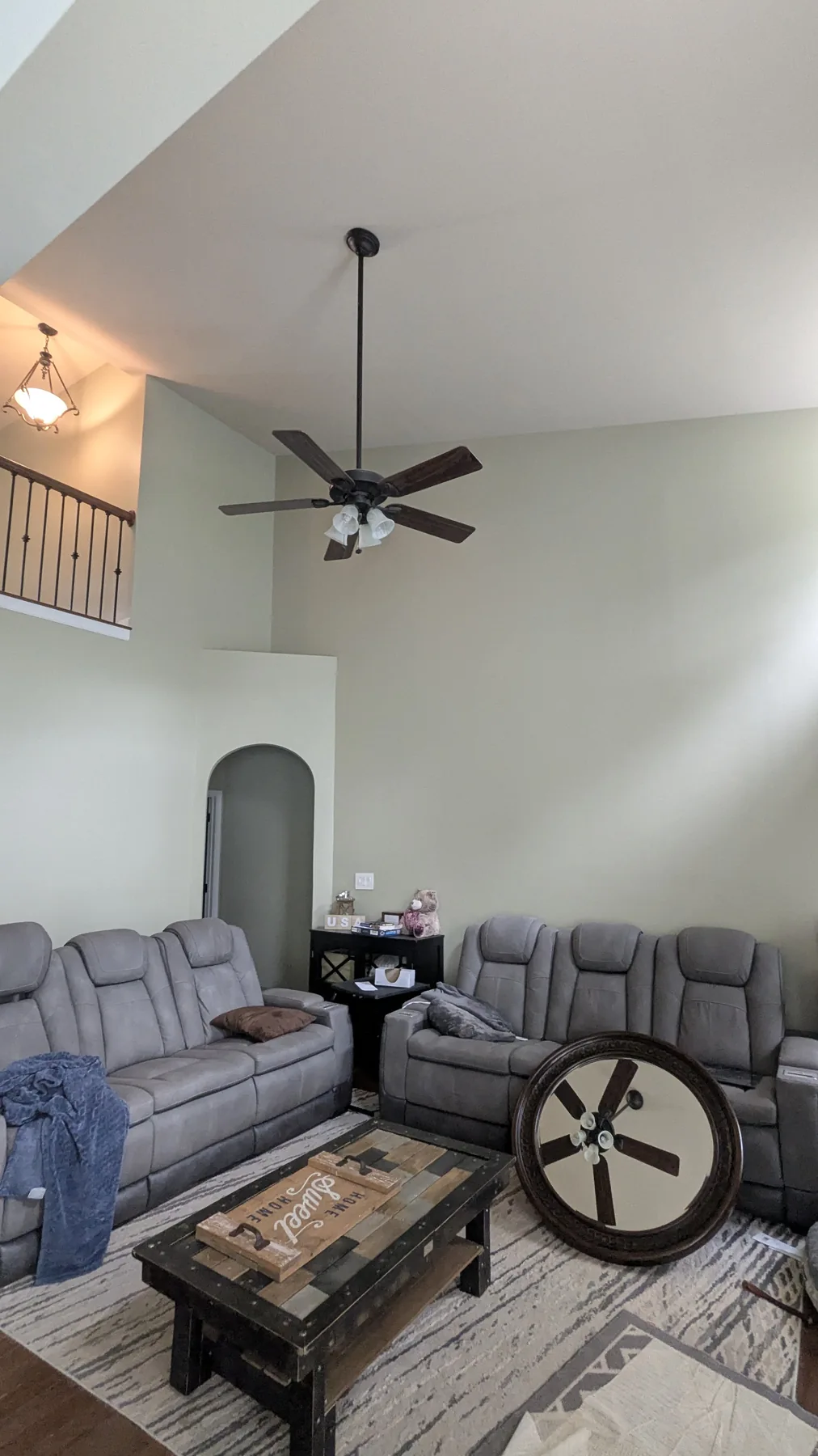 Living room with pale painted walls and a tall ceiling