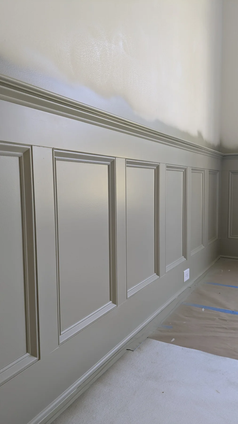 White painted wall paneling and trim