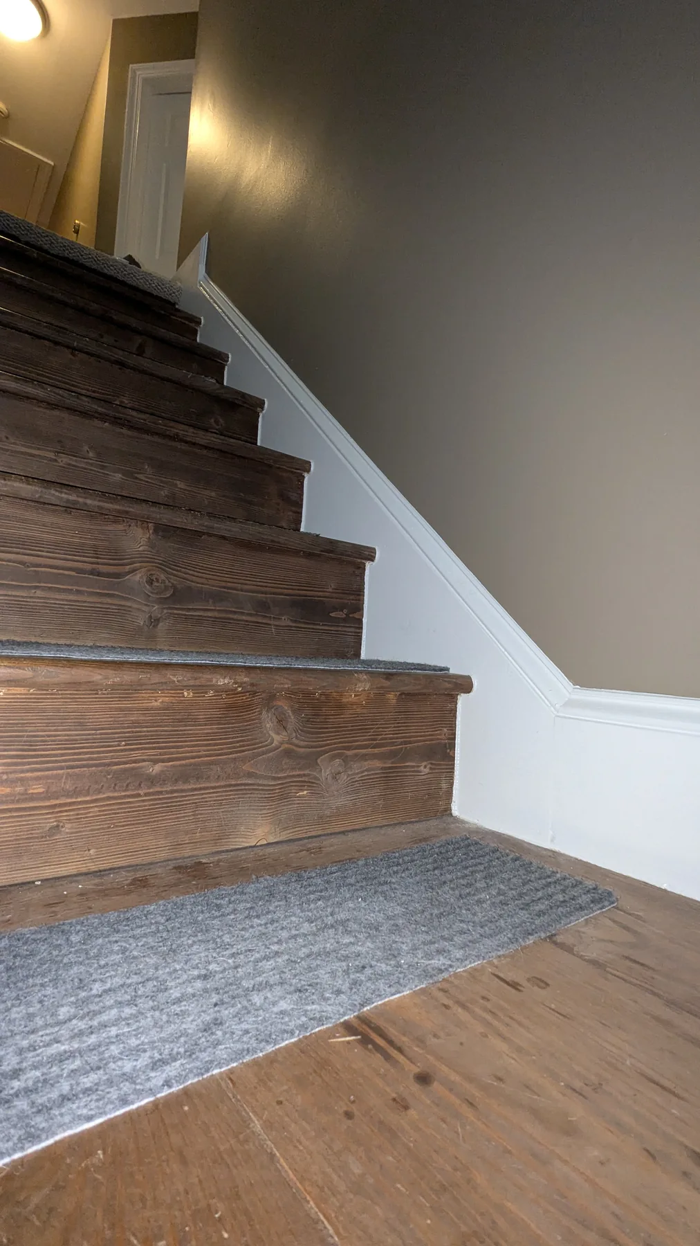 Stairwell with painted walls and white baseboards