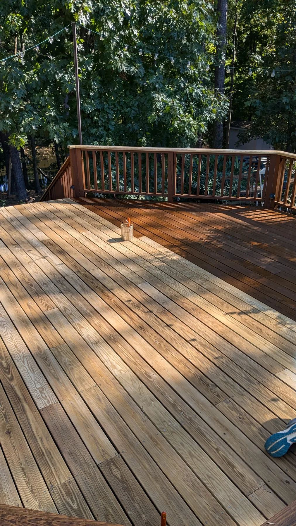 Wood deck boards and railings in a shaded garden